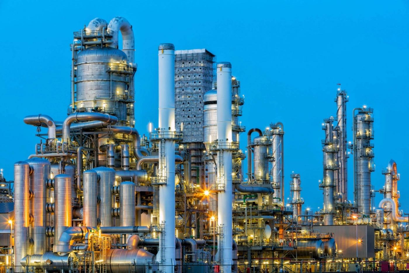 evening scene of chemical plant lit up | KLINGER UK