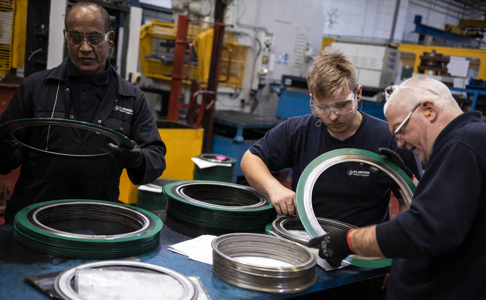 3 employees working on spiral wound kammprofile gasket at KLINGER UK